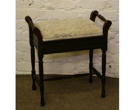 A Victorian mahogany turned and carved piano stool with re-upholstered seat and music storage.