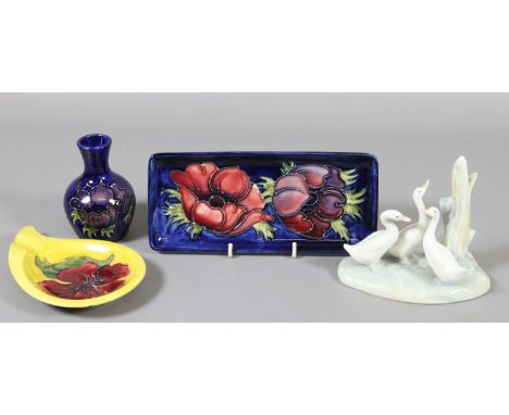 A Moorcroft Anemone pattern dish, small vase and a Hibiscus dish along with a Nao group of three geese.