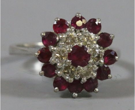 A ladies 18 carat white gold three tier ruby and diamond cluster ring. Size L.