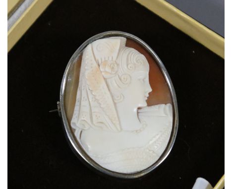 A carved shell cameo in white metal mount. Portrait of a Spanish maiden.