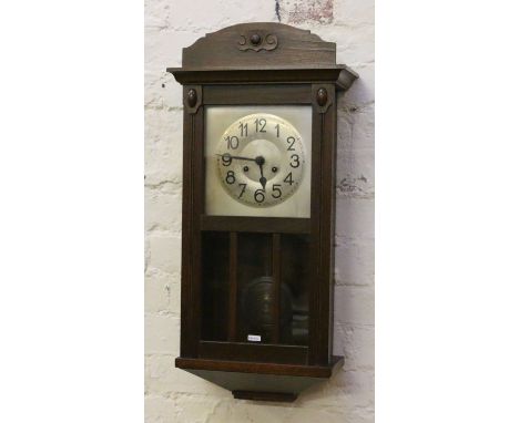An Edwardian mahogany cased eight day wall clock chiming on a coiled gong.