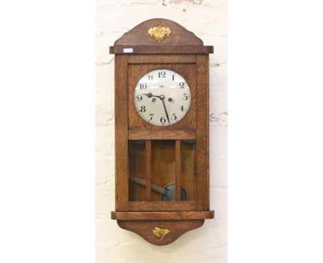 An Edwardian oak cased wall clock, the eight day movement half hour chiming on a coiled gong.