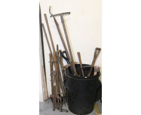A large collection of various tools to include iron slate rip, sash cramp, axes, adze and garden items.