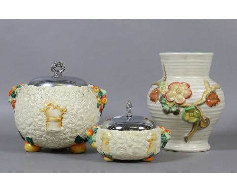 A Clarice Cliff Celtic Harvest pattern biscuit barrel and conserve jar along with a Clarice Cliff moulded pottery vase.