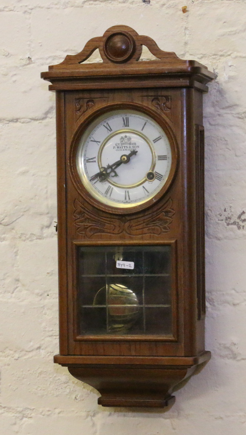 An oak cased wall clock by P Watts & Son chiming on a coiled gong.