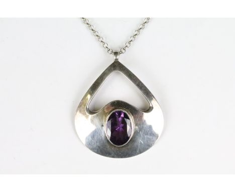 A 925 sterling silver modernist pendant with faceted amethyst centre stone mounted to 925 sterling silver belcher chain link 