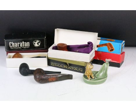A collection of boxed and unboxed smokers pipes to include Charatan examples together with a Wade ceramic pipe stand.