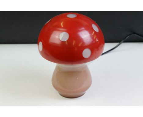 Glass toadstool mushroom lamp having a pink glass base with red painted shade. Measures approx 21cm tall. 