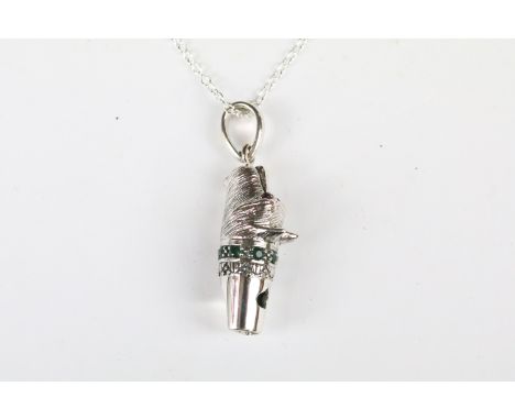 Silver dog whistle with ruby eyes and emerald collar, on silver chain 