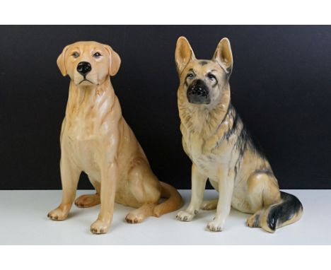 Two large ceramic dogs to include a Beswick German Shepherd and an unmarked Yellow Labrador (a/f). Measures 35cm and 34cm tal