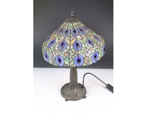 Tiffany style table lamp with leaded glass shade &amp; bronzed textured metal base, raised on four feet. Measures approx 47cm