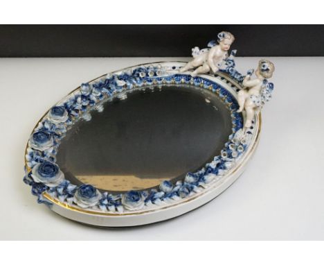 Sitzendorf porcelain dressing table mirror with blue &amp; white floral encrusting, putti with garland to top, gilt details, 