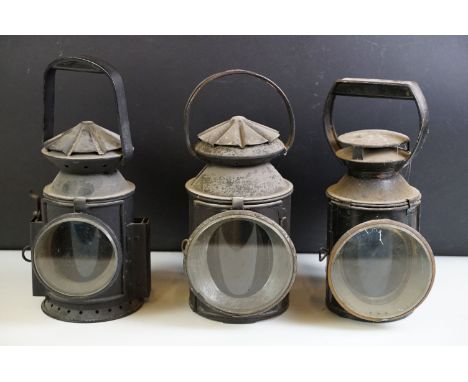 Railwayana - Three metal railway lamps to include a WWII era lamp (with plaque 'Wakefields 1945 Birmingham', with broad arrow