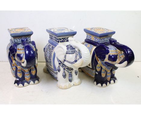 Three 20th century Chinese ceramic elephant garden seats, two with blue ground glaze, the other on white ground with scrollin