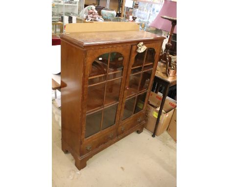 Early 20th century Walnut Display Cabinet with two glazed doors opening to adjustable shelves and two drawers below, raised o