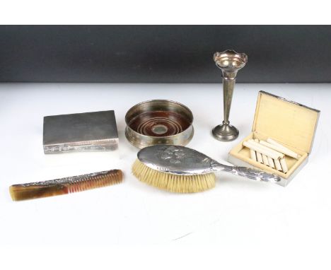 A collection of hallmarked sterling silver to include two cigarette boxes, bottle coaster, bud vase, brush and comb. 