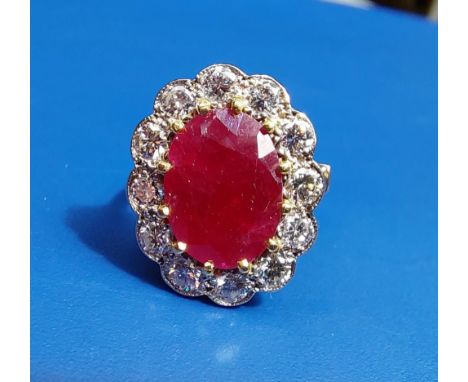 A ruby &amp; diamond oval cluster set 18ct gold ring.  Finger size L/M.