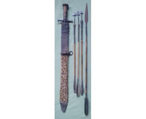 A North African sword in scabbard, 30" overall - blade seized in scabbard, together with four tribal arrows.