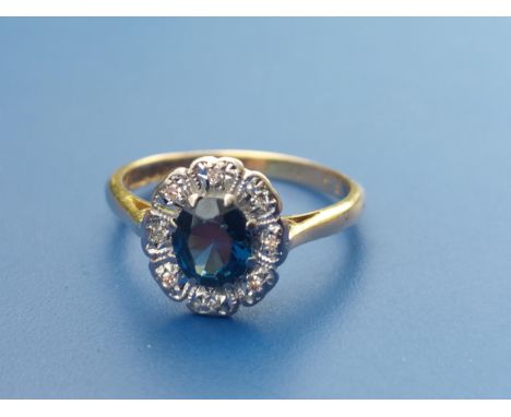 A sapphire &amp; diamond set oval cluster ring in 18ct gold.  Finger size K/L.