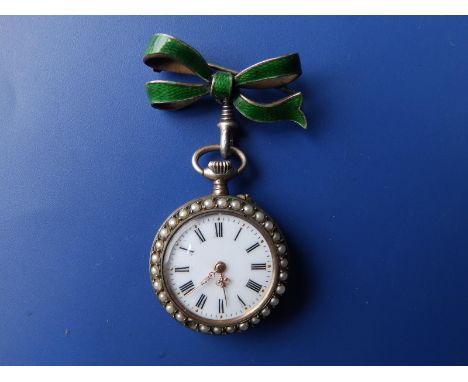 A ladies green enamelled silver fob watch with pearl set borders, white enamel dial, the back decorated in gold fleur-de-lys 