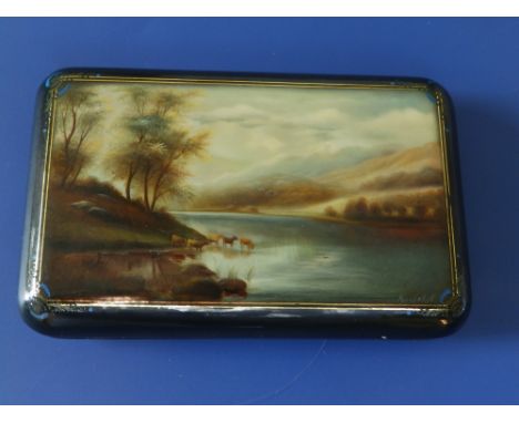 A Victorian black lacquered papier mache case, the rectangular hinged cover inset with an oval panel of mother-of-pearl givin