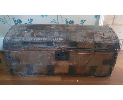 A large hide-covered trunk having studded decoration, original paper label, 33" across.