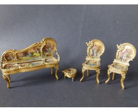 An Austrian enamelled gilt metal miniature four piece salon suite, decorated in the rococo style, comprising a settee, 4" acr