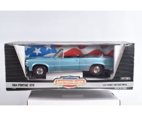 AN ERTL AMERICAN MUSCLE 1:12 SCALE DIECAST MODEL VEHICLE, a  1964 Pontiac GTO Convertible, light blue,  model no. 7308, appea