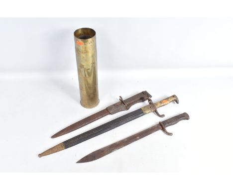 THREE NINETEENTH/TWENTIETH CENTURY BAYONETS ADN A BRASS SHELL CASE, the bayonets include an Imperial German bayonet and a sca