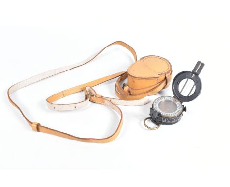 A WWII ERA COMPASS IN A TAN COLOURED LEATHER POUCH, the compass is dated 1939 and it is not working correctly due to the comp