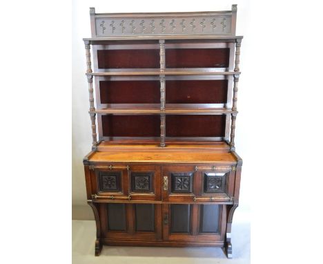 An Arts and Crafts Cabinet, the carved shelf back with turned pilasters with red velvet panels, the lower section with four d