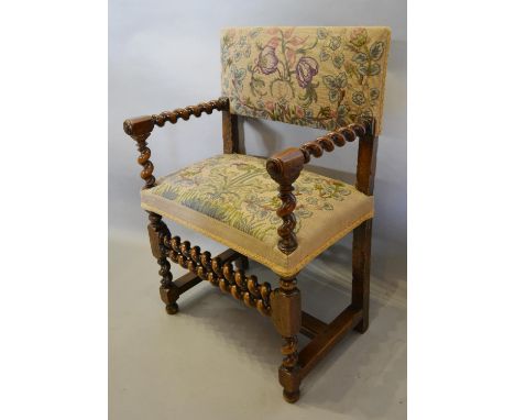 An 18th Century Walnut Armchair with Barley Twist Arms and similar legs with double barley twist stretcher, with later tapest