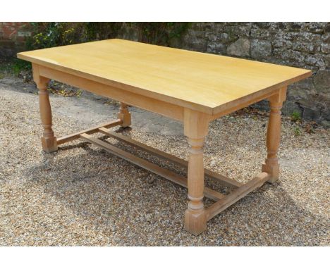 A Light Oak Refectory Style Dining Table, the plank top above a plain frieze with turned legs and stretchers, 183 x 91 cms 