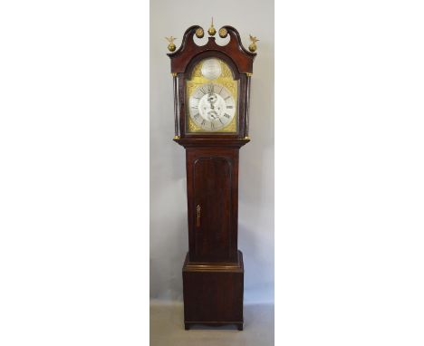A George III Oak and Mahogany Long Case Clock, the arched hood with broken swan neck pediment with three brass finials above 