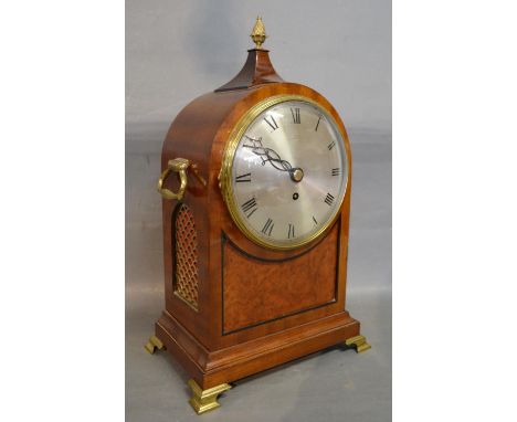 A Regency Mahogany Bracket Clock of Dome Form with brass pineapple finial and side carrying handles, raised upon brass feet, 