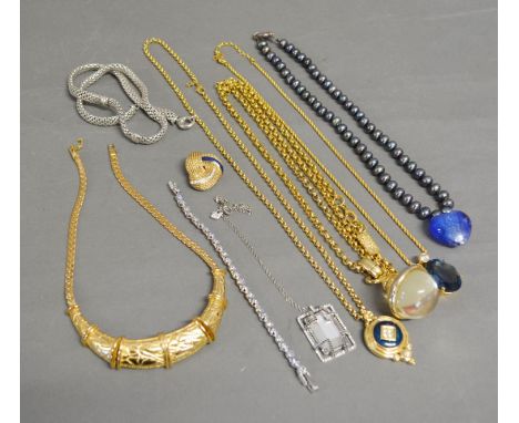 A Christian Dior Pendant with Chain with large oval blue stone, a Swarovski pendant and bracelet, a Burberry pendant, a Burbe
