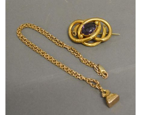 A 9ct. Gold Seal Fob with Chain together with a yellow metal brooch set oval amethyst 