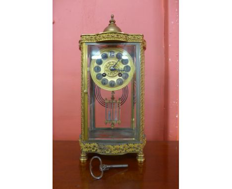 A 19th Century French ormolu and glass four sided table clock, with mercury pendulum 