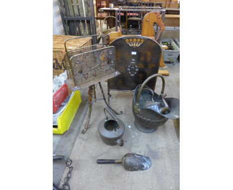 A Victorian Aesthetic Movement newspaper rack, a coal scuttle, a firescreen and a kettle