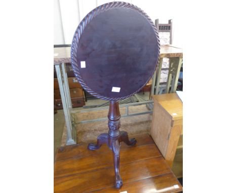 A Chippendale style carved mahogany circular tilt top tripod wine table 