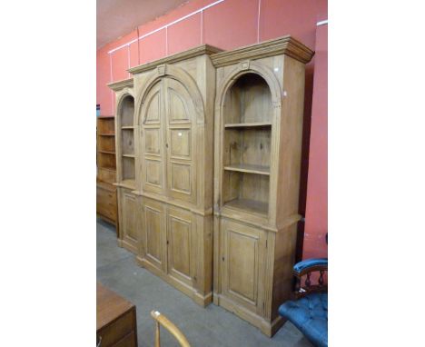 A large George III style pine architectural breakfront bookcase 