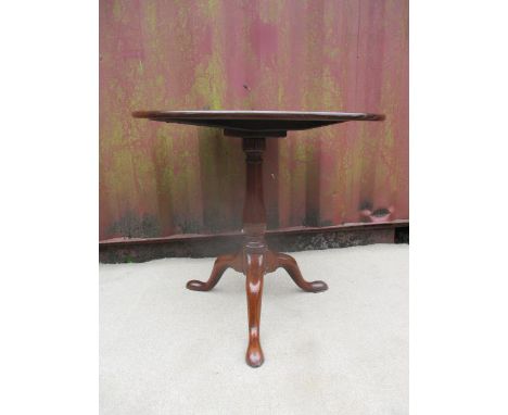 A George III mahogany pedestal table having a turned, baluster column, raised on a tripod base, 27 1/2" h, 30 1/2" dia 