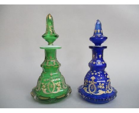 Two late 19th century Bohemian glass scent bottles of decagon form, one blue the other green, each decorated with flowers in 