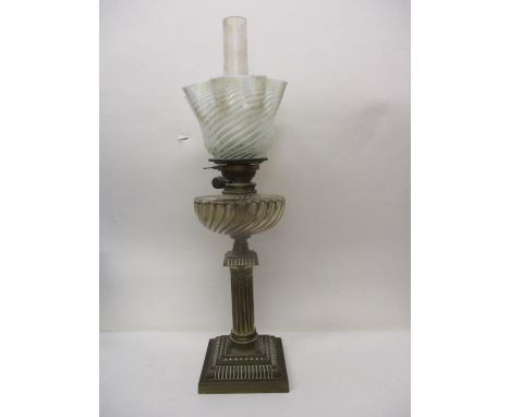 A Victorian A & NCS Messeners patent oil lamp with brass column base, gadrooned glass reservoir and period opalescent striped