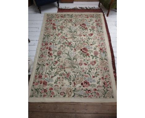 An Aubusson carpet with vases, flowers and foliage in pink, green, brown and black on a cream ground, 103" x 71" 