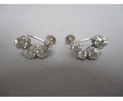 A pair of graduated four stone diamond earrings, each set in a white gold coloured metal setting stamped 9ct 