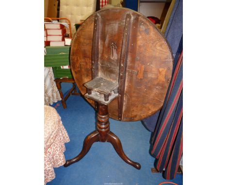 An Elm, two plank topped snap-top bird-cage mechanism circular occasional table standing on a turned pillar with three splay 
