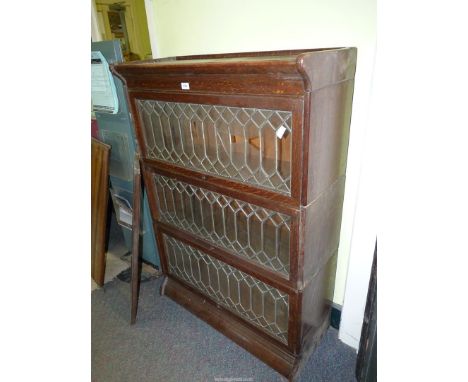 An Oak Globe Wernicke type three-stage Bookcase having leaded glazing and some components for another level including sides, 