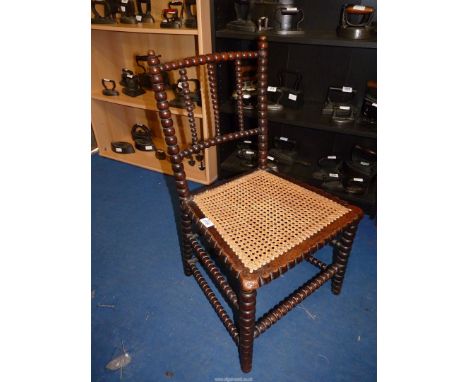 An Arts &amp; Crafts bobbin turned framed cane seated side chair. 30 1/4" high, 14 5/8" to the seat.