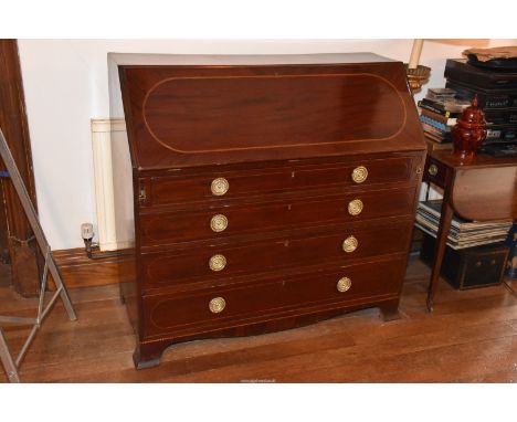 A 19th Century dark Mahogany Bureau, the light and dark-wood strung slope opening to reveal an interior with ten drawers, eig